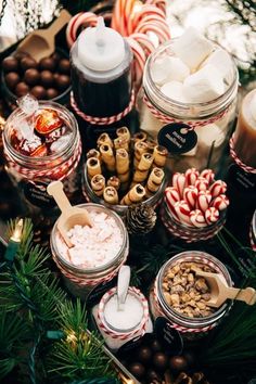 a table topped with lots of different types of candy and marshmallows on top of each other