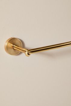 a gold handle on a white wall