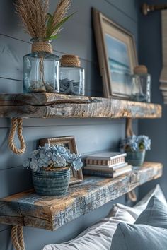 two wooden shelves holding vases, books and flowers on top of a bed in a bedroom