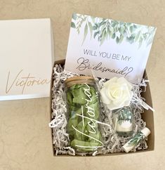 an open box with some items in it and a note that says, will you be my bridesmaid?