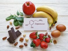 fruits and vegetables are arranged on a table with the words vitamins written in front of them