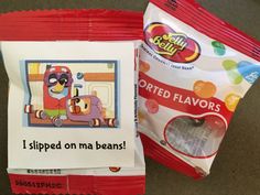 two bags of jelly beans sitting next to each other on a table with an ad for them