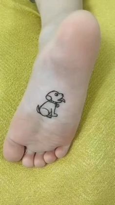 a person with a small dog tattoo on their foot