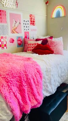 a bedroom decorated in pink and white with pictures on the wall