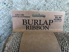 the label for burlap ribbon is on top of some fabric