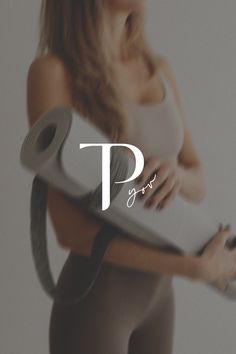 a woman in tights holding a yoga mat with the word pf on it