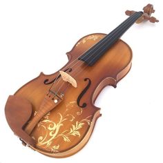 an old violin is sitting on a white surface and it's made out of wood