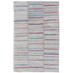 a multicolored rug with different stripes on the front and back of it,