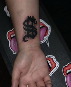 a person's hand with a tattoo on it