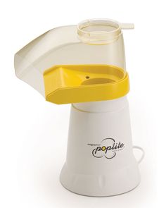 a white and yellow blender sitting on top of a table