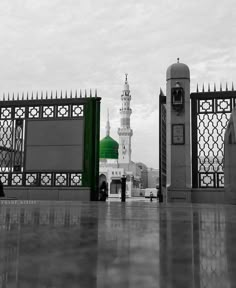 a black and white photo of a building with a green dome