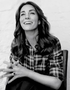 a black and white photo of a woman smiling