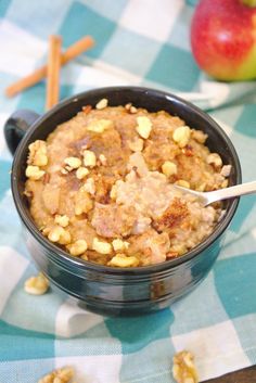 a bowl filled with oatmeal and nuts on top of a checkered table cloth