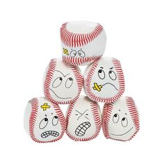 six baseballs with faces drawn on them are stacked up in a pyramid to show emotion