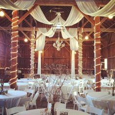 the inside of a barn decorated for a wedding