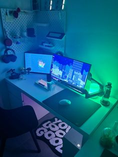 two computer monitors sitting on top of a desk in front of a monitor and keyboard