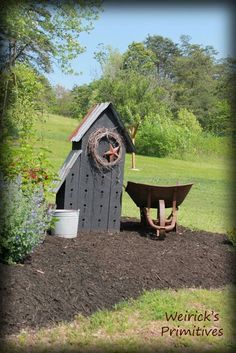 there is a wheelbarrow next to a shed