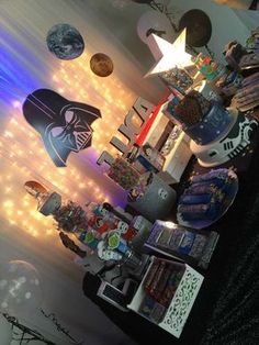 a room filled with decorations and lights on the wall, including star wars themed items