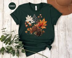 This beautiful Watercolor Fall Leaves T Shirt is great for fall or anytime you need an artistic reminder that change is beautiful! The design features a beautiful arrangement of watercolor leaves and pine cones. Purchase for yourself or as a gift for your favorite autumn or nature lover. This classic unisex jersey short sleeve tee fits like a well-loved favorite. Soft cotton and quality print make users fall in love with it over and over again. These t-shirts have-ribbed knit collars to bolster shaping. The shoulders are tapered for a better fit over time. Dual side seams hold the garment's shape for longer.  .: Made with 100% Airlume combed and ring-spun cotton, a lightweight fabric (4.2 oz/yd² (142 g/m that is easy to layer, breathable. Perfect for active and leisure wear.  .: The retail Multicolor Graphic Print T-shirt For Fall, Green Graphic Tee For Fall, Green Screen Print T-shirt For Fall, Watercolor Fall Leaves, Change Is Beautiful, Leaves Shirt, Fall Shirts Women, T Shirt Womens, Fall Tee