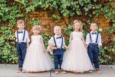 four young children in formal wear posing for the camera