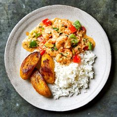 a white plate topped with rice and shrimp