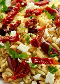 pasta salad with sun dried tomatoes, feta cheese and parsley on white plate