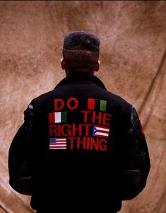 a man wearing a jacket with the words do the right thing written on it in red, white and green