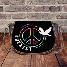 Coexist Saddle Bag | Luxury LGBTQ – stylesvista Lgbtq Fashion, Saddle Handbags, Unique Handbags, Bag Luxury, Saddle Bag, She Loves, High Top Shoes, Perfect Gift For Her, Vegan Friendly