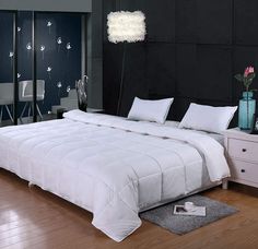 a white bed sitting on top of a hard wood floor