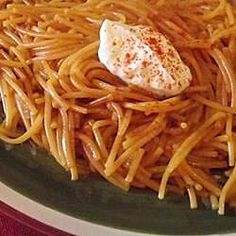 a plate full of spaghetti with an egg on top