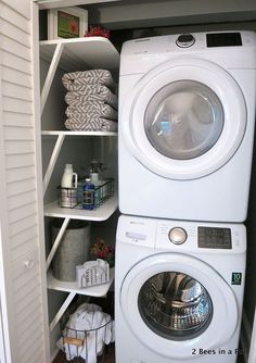 a white washer and dryer in a closet with shelving next to each other