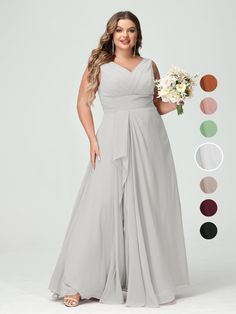 a woman in a long gray bridesmaid dress holding a bouquet and posing for the camera