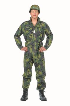 a man in camouflage is standing with his hands on his hips