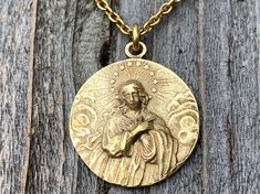 This is a solid gold bronze antique replica of a very rare Assumption of Mary medal from France. I am blessed to own this original and be able to share with you. The photographs do not capture the true beauty of this piece of art. Amazing depth and details! The oxidation and antiquing process highlights the gorgeous details. If you rub your fingers over the medal, Our Lady's face and body are very pronounced. The antique gold 2x3mm cable chain is 20 inches long and the medal is 1 inch round. A l Antique Finish Gold Jewelry For Memorial, Gold Antique Jewelry For Memorial, Antique Finish Gold Jewelry For Commemoration, Gold Antique Finish Jewelry For Memorial, Gold Antique Finish Jewelry For Commemoration, Assumption Of Mary, Cross Medal, Opening An Etsy Shop, I Am Blessed