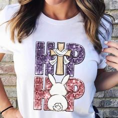 a woman wearing a white t - shirt with the words hip hop and a cross on it