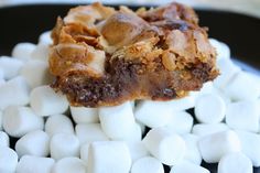 marshmallows and brownies on a black plate