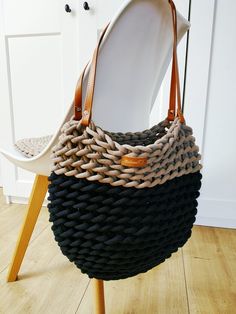 a black and brown bag sitting on top of a chair