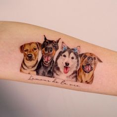 a woman's arm with three dogs on it