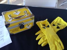 a yellow suitcase and gloves on a table