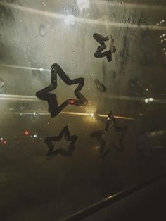 the stars are reflected in the wet window