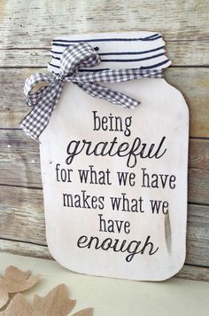 a mason jar with the words being grateful for what we have makes what we have enough