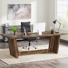 an office with a desk, chair and laptop on the floor in front of a window