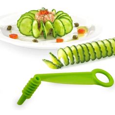 a plate with cucumbers, carrots and pickles on it next to a knife