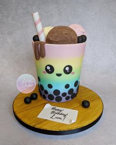 an ice cream sundae with chocolate and marshmallows in it on a wooden plate