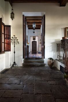 an entry way leading into a home with stone flooring