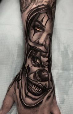 a man's hand with an evil clown face tattoo on the left arm and wrist