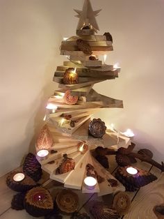 a christmas tree made out of wood and lit candles