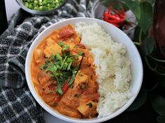 a white bowl filled with rice and curry