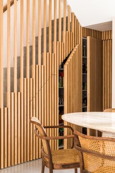 a room with wooden slats on the wall and a table in front of it