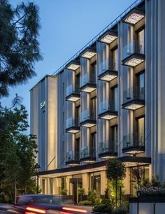 a very tall building with lots of windows and lights on it's sides at night